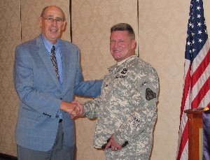 In March, Eisele (l) presents a TechNet memento to Col. Mike Zarbo, USA, project manager for instrumentation, targets and threat simulators, Program Executive Office of Simulation, Training and Instrumentation, in recognition of his speech at the luncheon.
